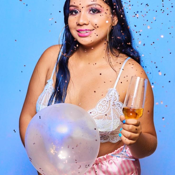 Kaveri Mehta, Lead Design Curator at Garden Studio Plain, reviewing corporate floral arrangements